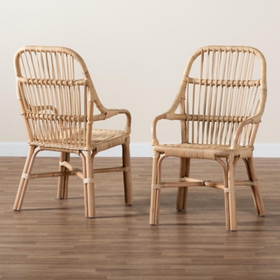 Two wicker dining chairs on wooden floor