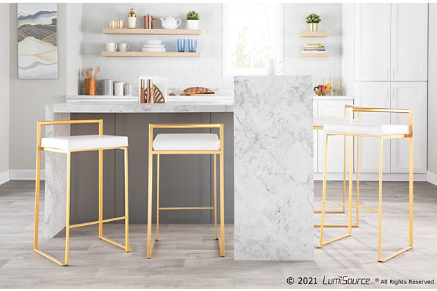 Longing for a less-is-more aesthetic? Go for gold with Fuji bar stools. A luxe goldtone finish lets the ultra-linear metal frame and backrest shine. Thickly padded seats are covered in a white leatherette fabric for a cool look and sumptuous comfort. Stackable design simply makes sense.Set of 2 | Made of metal | Foam cushioned seat | Polyurethane (faux leather) upholstery | Sturdy metal footrest | Stackable design | Assembly required