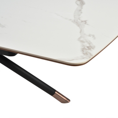 Corner of table top with marble pattern and rounded edge, leg with copper-tipped end in foreground