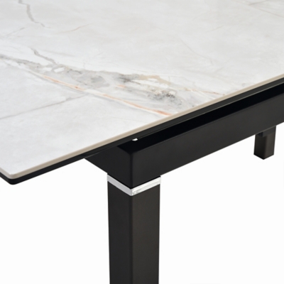 Edge detail of marble tabletop with black support rail beneath.