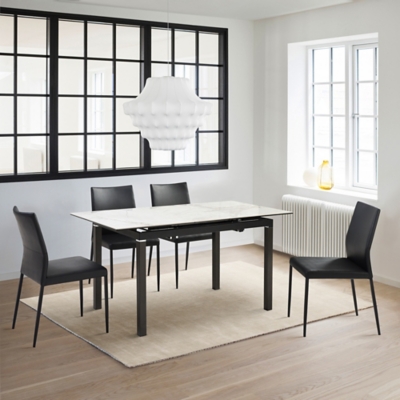 Dining room setup with a marble-top table and black legs, seating for four with chairs around the table.