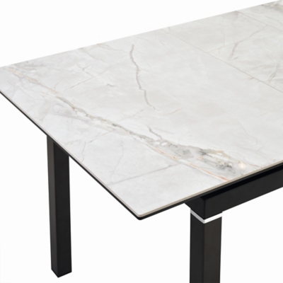 Corner of marble tabletop showing seam and edge detail with black leg.