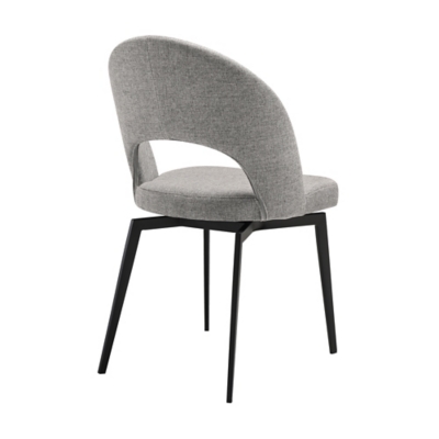 Grey upholstered dining chair with rounded back and black metal legs, side view.