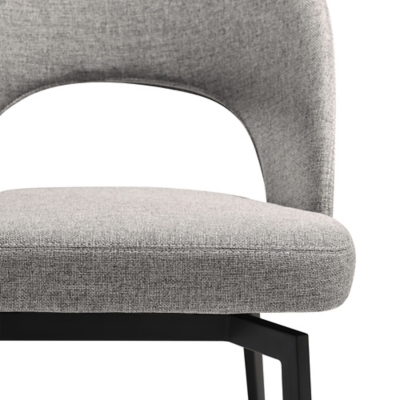 Close-up of grey upholstered chair seat and back with black metal legs.