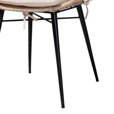 Close-up of the chair's black metal legs and cushion ties