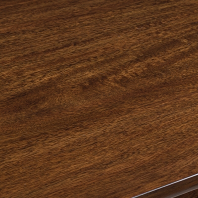 Close-up of rounded corner of wooden table top with leg visible