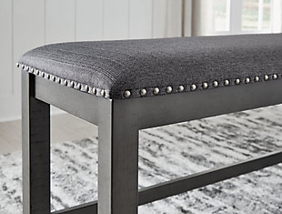 Going gray in the best possible way. The Myshanna dining bench wows with an utterly on-trend smoky gray finish. Its softly cushioned seat with gray textured upholstery and nailhead trim will have you lingering a little longer at mealtime. Just a touch of distressing helps it fit right in with your modern farmhouse decor.Made with solid hardwood frames | Antiqued gray finish | Woven polyester upholstery | Nailhead accents | Seats up to 3 | Assembly required | Estimated Assembly Time: 15 Minutes