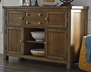 Moriville dining room server might be simple at first sight, but a closer look reveals beauty in the details. With the plank-effect cabinet doors and table top, distressed nutmeg finish and antiqued bronze-tone hardware, it’s simply beaming with charm. With a mix of drawer, cabinet and shelf space, this server will serve you well for years to come.Made of veneers, wood and engineered wood | Antiqued bronze-tone hardware | 2 smooth-gliding drawers (top drawer with felt lining) | 4 cabinets (lower cabinets each with 1 shelf) | Center display shelf | Assembly required | Excluded from promotional discounts and coupons | Estimated Assembly Time: 15 Minutes
