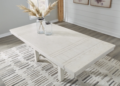 Dining table with a potted centerpiece in a bright room