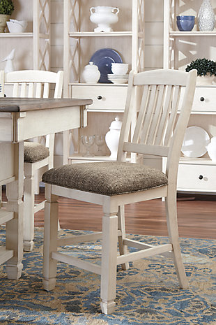 The beauty of the Bolanburg upholstered bar stool is something to savor. Designed to serve up comfort and flair, this rake-back bar stool entices with a cushioned seat covered in a heavy woven fabric that complements the antiqued white finish.Made of solid wood | Antiqued white finish | Heavy woven fabric upholstered seat | Assembly required | Excluded from promotional discounts and coupons | Estimated Assembly Time: 15 Minutes