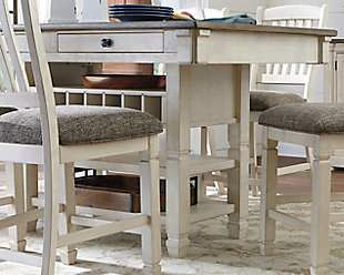 The beauty and practicality of the Bolanburg dining room counter table is something to savor. A two-tone textural finish gives this dining table with plank-effect top a double helping of charm. Four smooth-gliding drawers allow you to keep placemats, napkins and utensils right on hand. And if you love to entertain, you’re sure to toast this table’s built-in wine.Made of veneers, wood and engineered wood | Two-tone textural finish; antique white with weathered oak finished top | 4 drawers; 2 each on each side | Storage rack holds up to 7 wine bottles | Seats up to 6 | Assembly required | Dining chairs sold separately | Estimated Assembly Time: 30 Minutes