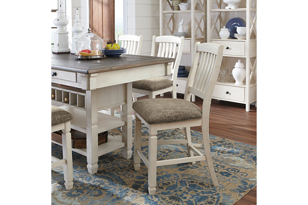 The beauty and practicality of the Bolanburg dining room counter table is something to savor. A two-tone textural finish gives this dining table with plank-effect top a double helping of charm. Four smooth-gliding drawers allow you to keep placemats, napkins and utensils right on hand. And if you love to entertain, you’re sure to toast this table’s built-in wine.Made of veneers, wood and engineered wood | Two-tone textural finish; antique white with weathered oak finished top | 4 drawers; 2 each on each side | Storage rack holds up to 7 wine bottles | Seats up to 6 | Assembly required | Dining chairs sold separately | Estimated Assembly Time: 30 Minutes
