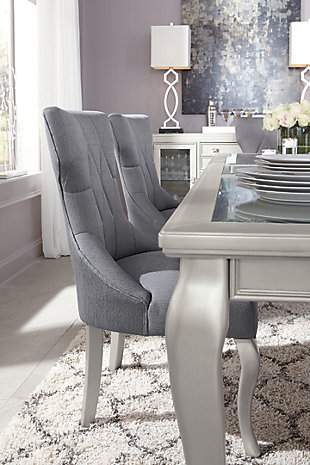 The Coralayne dining room extension table relishes the glitz and glam befitting silver screen queens. Curvaceous cabriole legs are truly alluring, as is the exquisite frame's lightly metallic finish. Faux shagreen showing through clear glass inlays melds a cool textural look with a smooth tabletop surface.Made of veneers, wood and engineered wood | Subtle metallic sheen finish | Beveled clear glass inlays | Faux shagreen embossing on tabletop | Cabriole legs | Includes 1 removable leaf | Seats up to 8 with removable leaf | Assembly required | Dining chairs sold separately | Estimated Assembly Time: 15 Minutes