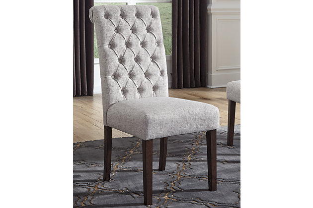 You love the look of traditional furniture—as long as it’s not overly formal. Behold the best of both worlds in the Adinton upholstered dining room chair. The combination of classic and up-to-date design proves that opposites really do attract. Sleek lines and a rich finish showcase its craftsmanship, while sumptuous cushioning and button-tufted upholstery attest to its comfort. With these fine details, you can dress up a room, yet keep it feeling casual for today's lifestyle.Made of wood | Warm brown finish | Soft woven polyester linen hued upholstery | Cushioned seats | Curved, button-tufted backs | Estimated Assembly Time: 30 Minutes