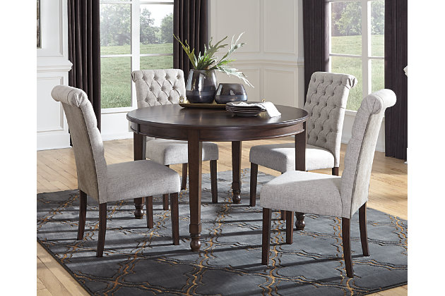 You love the look of traditional furniture—as long as it’s not overly formal. Behold the best of both worlds in the Adinton dining room extension table. The combination of classic and up-to-date design proves that opposites really do attract. Starburst veneer pattern and cross banded border add a distinctive touch to the table’s versatile profile—just pull it apart and drop in the extension to change it from round to oval. With these fine details, you can dress up a room, yet keep it feeling casual for today's lifestyle.Made of wood, birch veneers and engineered wood | Reddish brown finish | Separate extension leaf | Table extends by pulling both ends and dropping in leaf | Seats up to 6 fully extended | Assembly required | Estimated Assembly Time: 15 Minutes