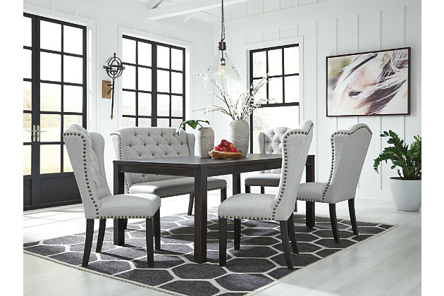 With its fashion-forward take on farmhouse styling, the Jeanette 6-piece dining room extension table set is a feast for the senses. The table’s clean-lined Parsons styling is a timeless choice that works so well with an eclectic seating arrangement featuring wingback chairs and a bench. Deep button tufting enhances the luxurious look designed to make gathering around the table an easy-elegant experience.Includes extension table, 4 chairs and bench | Made of wood, veneers and engineered wood | Dry vintage black finish | Distressed aesthetic | Table extends to seat 6 | Dining chairs and bench made of wood | Polyester upholstery over foam cushioned seat | Button tufted back | Nailhead trim | Assembly required | Estimated Assembly Time: 165 Minutes