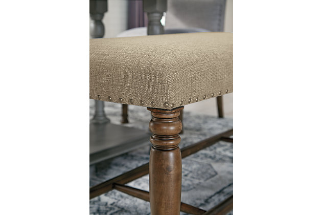 The Lettner upholstered dining room bench brings a tempting mix of comfort and flair to the table. This easy-elegant bench with substantial stretcher design is covered in an oatmeal-colored fabric that complements anything and everything. Nailhead trim is so on trend.Made of wood | Oatmeal-color polyester fabric over foam cushioned seat | Nailhead trim | Assembly required | Estimated Assembly Time: 15 Minutes