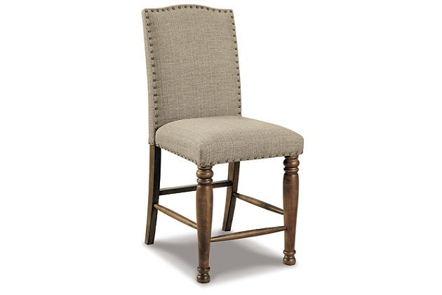 The Lettner upholstered dining room bar stool brings a tempting mix of comfort and flair to the table. This easy-elegant bar stool with subtle camelback design is covered in an oatmeal-colored fabric that complements anything and everything. Nailhead trim is so on trend.Made of wood | Oatmeal-color polyester fabric over foam cushioned seat | Nailhead trim | Assembly required | Estimated Assembly Time: 30 Minutes