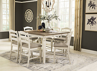 Bon appétit. The Realyn 7-piece counter height dining set has all the right ingredients for a French country-inspired feast for the senses. The extension table's antiqued two-tone aesthetic of chipped white with a distressed wood finish offers up a double serving of charm. With their rounded ladderback styling and plush cushioned seats, the counter-height bar stools provide a comfortable dining experience.Includes counter height extension table with leaf and 6 counter height bar stools  | Table made of wood, veneer and engineered wood and cast resin components | Chipped white with distressed wood finish | Table with separate extension leaf | Bar stools made of wood and engineered wood with polyester upholstery | Seats up to 6 fully extended | Assembly required | Estimated Assembly Time: 195 Minutes