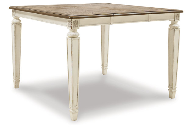 Bon appétit. The Realyn counter-height extension table has all the right ingredients for a French country-inspired feast for the eyes. Antiqued two-tone aesthetic pairs a chipped white with a distressed wood finished top for a double serving of charm. Drop-in leaf extends table to a square allowing you to comfortably seat six.Made of veneers, wood and engineered wood with some cast resin components | Antiqued two-tone finish | Separate extension leaf | Table extends by pulling both ends and dropping in leaf | Seats up to 6 | Dining chairs sold separately | Assembly required | Estimated Assembly Time: 15 Minutes