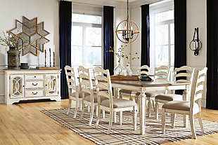 Bon appétit. The Realyn 9-piece dining room set has all the right ingredients for a French country-inspired feast for the eyes. Drop-in leaf allows you to transform the intimate square dining table into a gracious extension table that comfortably seats eight. Antiqued two-tone aesthetic pairs chipped white with a distressed wood finished top for a double serving of charm. With its rounded ladderback styling and plushly cushioned seat, this dining room chair is sure to entice you to linger a little longer.Includes dining table and 8 chairs | Assembly required | Table made of veneer, wood and engineered wood | Antiqued two-tone finish | Separate extension leaf | Table extends by pulling both ends and dropping in leaf | Table seats up to 8 | Chair made with wood and engineered wood | Distressed, chipped white finish | Ladderback styling | Polyester upholstery over foam cushioned seat | Estimated Assembly Time: 270 Minutes