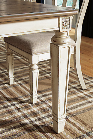 Bon appétit. The Realyn dining room extension table has all the right ingredients for a French country-inspired feast for the eyes. Antiqued two-tone aesthetic pairs a chipped white with a distressed wood finished top for a double serving of charm. Drop-in leaf allows you to comfortably accommodate eight.Made of veneers, wood and engineered wood with some cast resin components | Antiqued two-tone finish | Separate extension leaf | Table extends by pulling both ends and dropping in leaf | Seats up to 8 | Dining chairs sold separately | Assembly required | Estimated Assembly Time: 30 Minutes
