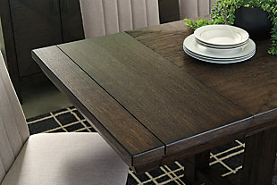 Feast your eyes on the Dellbeck dining table. Its inlaid veneer tabletop supported by a four-post trestle base is a look worth lingering over. When unexpected guests drop by, two extension leaves make entertaining a breeze.Made of wood, veneers and engineered wood | Dark brown finish | 2 removable extension leaves | Seats up to 8 | Assembly required | Dining chairs sold separately | Estimated Assembly Time: 30 Minutes