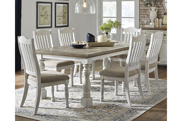 Have your fill of modern farmhouse style with the Havalance 7-piece dining set. Distressed, vintage-style finishes blend weathered neutrals for an utterly charming effect. The table boasts robust legs for a hearty, substantial look while the bent slat back design and cushioned upholstered seat of the dining chairs cater to your aesthetic.Includes dining table and 6 dining side chairs | Table made of pine wood, pine veneer and engineered wood with two-tone distressed finish: weathered gray top; vintage white base | Table seats 6-8 | Chairs made of wood and engineered wood with foam cushioned seat upholstered in polyester oatmeal-color fabric | Distressed vintage white finish | Assembly required | Estimated Assembly Time: 195 Minutes