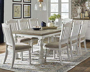 Have your fill of modern farmhouse style with the Havalance 9-piece dining set. Distressed, vintage-style finishes blend weathered neutrals for an utterly charming effect. The table boasts robust legs for a hearty, substantial look while the bent slat back design and cushioned upholstered seat of the dining chairs cater to your aesthetic.Includes dining table and 8 dining side chairs | Table made of pine wood, pine veneer and engineered wood with two-tone distressed finish: weathered gray top; vintage white base | Table seats 6-8 | Chairs made of wood and engineered wood with foam cushioned seat upholstered in polyester oatmeal-color fabric | Distressed vintage white finish | Assembly required | Estimated Assembly Time: 255 Minutes