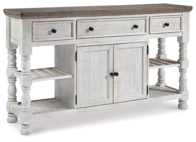 Have your fill of modern farmhouse style with the Havalance dining room server. Distressed two-tone treatment blends a weathered gray with vintage white for an utterly charming effect. Robust posts and thick mouldings lend a hearty, substantial look that feels right at home. Along with drawer and cabinet storage, reversible wine rack/shelves add to its toast-worthy appeal.Made of pine wood, pine veneer and engineered wood | Two-tone distressed finish: weathered gray top; vintage white base | 2 reversible wine rack/shelves | 3 smooth-gliding drawers (with felt lining) | Double-door cabinet with single-shelf storage | Aged iron-color knobs | Assembly required | Estimated Assembly Time: 60 Minutes