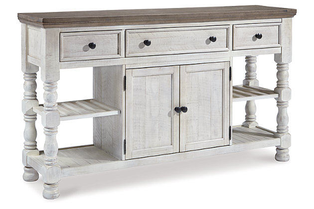 Have your fill of modern farmhouse style with the Havalance dining room server. Distressed two-tone treatment blends a weathered gray with vintage white for an utterly charming effect. Robust posts and thick mouldings lend a hearty, substantial look that feels right at home. Along with drawer and cabinet storage, reversible wine rack/shelves add to its toast-worthy appeal.Made of pine wood, pine veneer and engineered wood | Two-tone distressed finish: weathered gray top; vintage white base | 2 reversible wine rack/shelves | 3 smooth-gliding drawers (with felt lining) | Double-door cabinet with single-shelf storage | Aged iron-color knobs | Assembly required | Estimated Assembly Time: 60 Minutes