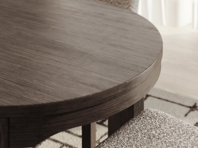 Close-up of round dark wood dining table top showing wood grain