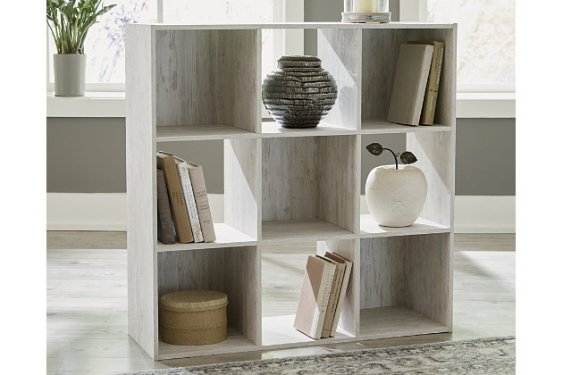 If it’s coastal chic or cottage quaint style you long for, the Paxberry whitewashed nine-cube organizer invites you to go to town. Its distinctive weatherworn finish conveys an easy-breezy sensibility, perfect for a restful bedroom retreat. Open and closed backs make it abundantly practical.Made with engineered wood (MDF/particleboard) and decorative laminate | Whitewash replicated worn through paint with authentic touch | Accommodates any 10.5W x 10.5D x 11H storage bin | Assembly required | Estimated Assembly Time: 25 Minutes