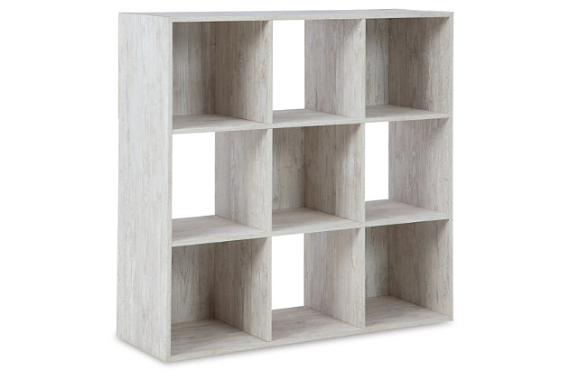 If it’s coastal chic or cottage quaint style you long for, the Paxberry whitewashed nine-cube organizer invites you to go to town. Its distinctive weatherworn finish conveys an easy-breezy sensibility, perfect for a restful bedroom retreat. Open and closed backs make it abundantly practical.Made with engineered wood (MDF/particleboard) and decorative laminate | Whitewash replicated worn through paint with authentic touch | Accommodates any 10.5W x 10.5D x 11H storage bin | Assembly required | Estimated Assembly Time: 25 Minutes