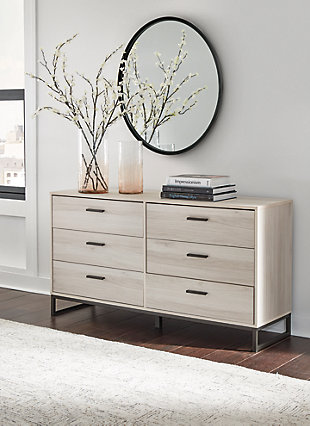 Light and bright, the Socalle dresser is inspired by chic design. A natural finish over replicated oak grain offers an authentic touch to this so-cool piece. Beautifully blend the hues of natural living with the edginess of your modern lifestyle.Made of engineered wood and decorative laminate | Natural finish over replicated oak grain with authentic touch | 6 smooth-gliding drawers | Dark pewter-tone pulls | Vinyl wrapped drawer sides and back for extra durability | Safety is a top priority, clothing storage units are designed to meet the most current standard for stability, ASTM F 2057 (ASTM International) | Drawers extend out to accommodate maximum access to drawer interior while maintaining safety | Assembly required | Estimated Assembly Time: 50 Minutes