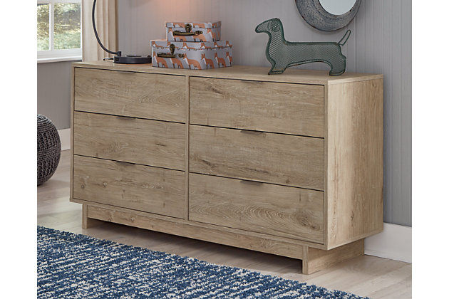 Bringing big style to small living areas, the Oliah dresser is a smart, space-saving choice for those with an eye for contemporary design. Its clean-lined profile and understated refinements create such a simple silhouette that works in so many settings. Flush-mount drawers with integrated pulls keep this dresser on the cutting edge of cool.Made with engineered wood (MDF/particleboard) and decorative laminate | Dry, light finish with replicated oak grain and authentic touch | 6 spacious smooth-gliding drawers; vinyl-wrapped sides and back for extra durability | Brushed nickel-tone tab pulls | Safety is a top priority, clothing storage units are designed to meet the most current standard for stability, ASTM F 2057 (ASTM International) | Drawers extend out to accommodate maximum access to drawer interior while maintaining safety | Assembly required | Estimated Assembly Time: 40 Minutes