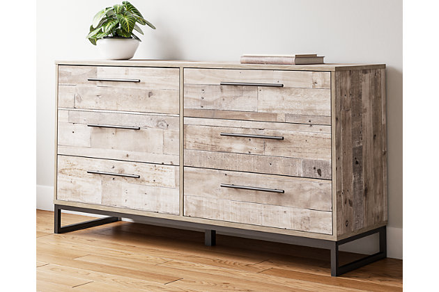 Part beach chic, part urban hip, the Neilsville dresser is everything you dreamed of, at a comfortably cool price. The butcher block whitewash finish over replicated pine grain lends a richly relaxed aesthetic that suits your sensibility. Dark pewter-tone drawer pulls and sled legs add a high design element. What an easy-breezy choice for a naturally beautiful bedroom retreat.Made of engineered wood and decorative laminate | Butcher block, whitewash finish over replicated pine grain with authentic touch | Dark pewter-tone hardware and metal sled legs | 6 smooth-gliding drawers | Vinyl wrapped drawer sides and back for durability | Safety is a top priority, clothing storage units are designed to meet the most current standard for stability, ASTM F 2057 (ASTM International) | Drawers extend out to accommodate maximum access to drawer interior while maintaining safety | Assembly required | Estimated Assembly Time: 50 Minutes