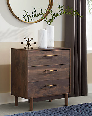 At the intersection of industrial cool and chic sophistication you’ll find the Calverson three-drawer chest. The rich brown finish over replicated walnut wood grain and burnished goldtone handles offer an authentic touch that plays well any way you style it. Simple and elegant in its design, this piece keeps your home decor grounded while elevating your modern style.Made of engineered wood (MDF/particleboard) and decorative laminate | Rich brown finish over replicated walnut wood grain with authentic touch | Burnished goldtone pulls | 3 smooth-gliding drawers | Vinyl wrapped drawer sides and back for extra durability | Safety is a top priority, clothing storage units are designed to meet the most current standard for stability, ASTM F 2057 (ASTM International) | Drawers extend out to accommodate maximum access to drawer interior while maintaining safety | Assembly required | Estimated Assembly Time: 35 Minutes