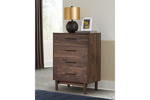 At the intersection of industrial cool and chic sophistication you’ll find the Calverson chest. The rich brown finish over replicated walnut wood grain and burnished goldtone handles offer an authentic touch that plays well any way you style it. Simple and elegant in its design, this piece keeps your home decor grounded while elevating your modern style.Made with engineered wood (MDF/particleboard) and decorative laminate | Rich brown finish over replicated walnut wood grain with authentic touch | Burnished goldtone pulls | 4 smooth-gliding drawers | Vinyl wrapped drawer sides and back for extra durability | Safety is a top priority, clothing storage units are designed to meet the most current standard for stability, ASTM F 2057 (ASTM International) | Drawers extend out to accommodate maximum access to drawer interior while maintaining safety | Assembly required | Estimated Assembly Time: 40 Minutes