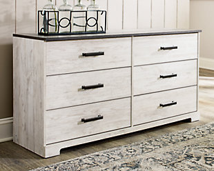 Give provincial a new meaning with the chic look of the Shawburn dresser. The two-tone finish keeps this piece light and fresh while the warm pewter-tone hardware adds an industrial touch. The distressed whitewashed body adds a delightfully homespun charm to your space.Made of engineered wood and decorative laminate | Whitewash replicated worn through paint | Top with rustic gray planked replicated oak grain with authentic touch | Pewter-tone pulls | 6 smooth-gliding drawers | Vinyl wrapped drawer sides and back for extra durability | Safety is a top priority, clothing storage units are designed to meet the most current standard for stability, ASTM F 2057 (ASTM International) | Drawers extend out to accommodate maximum access to drawer interior while maintaining safety | Assembly required | Estimated Assembly Time: 50 Minutes