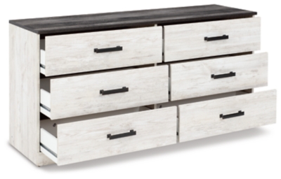 Give provincial a new meaning with the chic look of the Shawburn dresser. The two-tone finish keeps this piece light and fresh while the warm pewter-tone hardware adds an industrial touch. The distressed whitewashed body adds a delightfully homespun charm to your space.Made with engineered wood (MDF/particleboard) and decorative laminate | Whitewash replicated worn through paint | Top with rustic gray planked replicated oak grain with authentic touch | Pewter-tone pulls | 6 smooth-gliding drawers | Vinyl wrapped drawer sides and back for extra durability | Safety is a top priority, clothing storage units are designed to meet the most current standard for stability, ASTM F 2057 (ASTM International) | Drawers extend out to accommodate maximum access to drawer interior while maintaining safety | Assembly required | Estimated Assembly Time: 50 Minutes