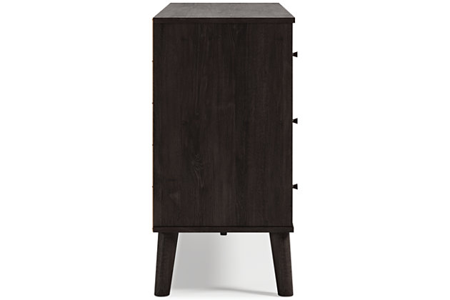 The perfect marriage of simple and contemporary style, the Piperton dresser is a charming addition to your home. It sports an expressive two-tone look, with a dark charcoal finish over replicated oak grain with an authentic touch and a replicated sugarberry wood grain. Ball bearing glides offer smooth opening and closing of the drawers, while matte black knobs and splay legs add a finishing touch.touch. Made of engineered wood (MDF/particleboard) and decorative laminate | Two-toned with dark charcoal finish over replicated oak grain and a replicated sugarberry wood grain | 6 smooth-gliding drawers with vinyl-wrapped sides and back | Matte black knobs | Splay legs | Safety is a top priority, clothing storage units are designed to meet the most current standard for stability, ASTM F 2057 (ASTM International) | Drawers extend out to accommodate maximum access while maintaining safety | Assembly required | Estimated Assembly Time: 60 Minutes