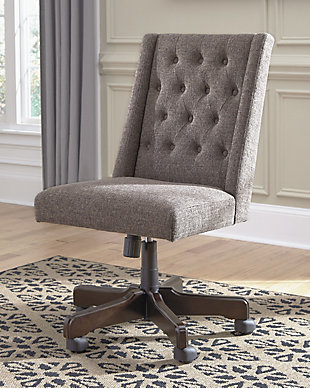 You deserve a touch of indulgence—especially when you’re hard at work. That’s what makes this upholstered swivel desk chair so alluring. Covered in a textured graphite fabric with button tufting and wingback flair, it’s a desk chair that makes work look a lot more pleasurable.Smooth 360-degree swivel | Metal, plastic and wood base | Casters for easy movement | Cushioned seat with button-tufted polyester upholstery | Adjustable seat height with manual tilt | Assembly required | Estimated Assembly Time: 15 Minutes