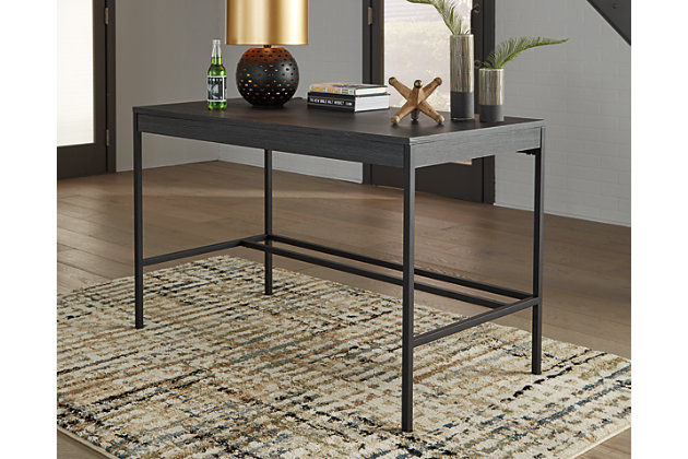 Elevate your home office with the simply sensational Yarlow home office desk. Pairing a dark wood grain look with tubular black metal base for modern appeal, this minimalistic desk with ample work space is dressed to impress in a no-muss, no-fuss way.Dark decorative wood grain laminate over engineered wood | Black matte metal legs | Stretcher styling | Assembly required | Estimated Assembly Time: 30 Minutes