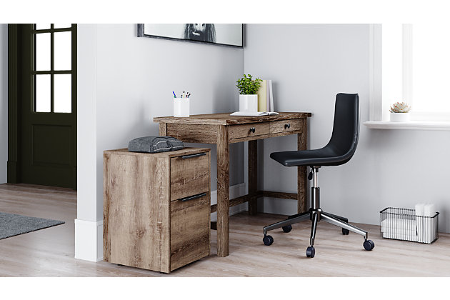 Clean-lined and contemporary—but far from stark—the Arlenbry home office desk is a fresh style awakening. Sleek scale makes it a natural fit for smaller spaces. Effortlessly combining modern farmhouse design with urban attitude, the replicated weathered oak grain plays perfectly with the chic yet earthy aesthetic.Made of decorative laminate and engineered wood | Replicated weathered oak grain | 2 drawers | Designed for easy cord management | Assembly required | Estimated Assembly Time: 15 Minutes