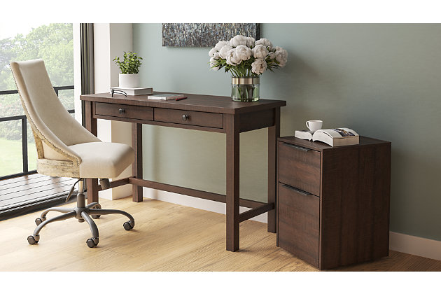 Whether you lean towards modern farmhouse or urban industrial design, the clean-lined profile of the Camiburg 2-drawer desk is an essential component to any well-equipped home office. Sleek and slim, it’s just enough furniture to complete your space without overloading your look.Made of engineered wood and laminated paper | Replicated rough-sawn wood grain | 2 smooth-operating drawers with ball bearing side glides | Designed for easy cord management | Assembly required | Estimated Assembly Time: 15 Minutes
