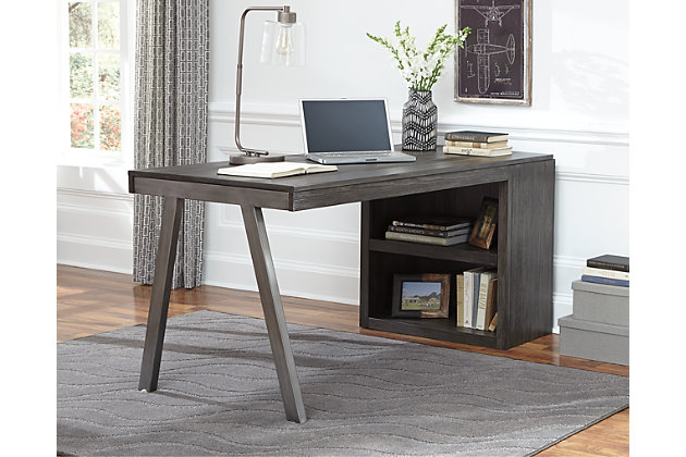 Minimizing the fuss with crisp, clean lines, the Raventown modular desk with low bookcase goes to town on wonderfully weathered texture inspired by driftwood. This casually cool choice in home office furniture sports a gray-brown finish over pine veneers that’s easy on the eyes and sure to please. Minimalist-chic design proves that less can be so much more.Assembly required | Metal desk base in nickel-tone finish | Bookcase with adjustable shelf | Made of wood, pine veneers and engineered wood with wire-brushed gray-brown finish