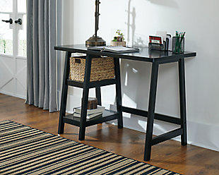 Space-challenged rooms call for simply chic style: like the Mirimyn small home office desk in black. Clean and lean, this desk’s classic trestle design always works. Pair of open shelves and natural water hyacinth basket provide essential storage.Made with solid wood, veneer and engineered wood | Distressed finish | Includes water hyacinth basket | 2 fixed shelves | Assembly required | Estimated Assembly Time: 30 Minutes