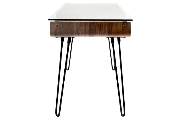 Feel free to bend the rules with this mixed media home office desk. A unique merger of mid-century inspiration and urban attitude, it’s dressed to impress with curvaceous bent wood, hairpin legs and a clear tempered glass top. What a great choice for small spaces!Metal hairpin legs in black | Tempered glass top | Bent wood storage shelf with walnut finish | Assembly required