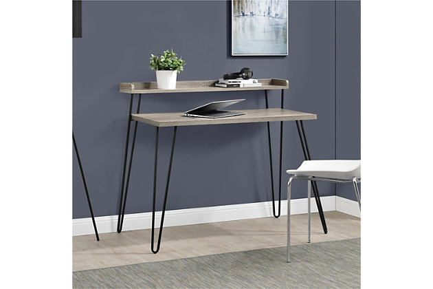 With a mix of industrial and urban styles, this desk has a small footprint but affords two levels of storage—perfect for tight spaces. With hairpin legs that harken back to mid-century design, this standout piece lends great functionality and looks incredibly cool doing so.Made of laminated engineered wood and powdercoated metal | Light walnut woodgrain finish | Metal hairpin legs | Assembly required